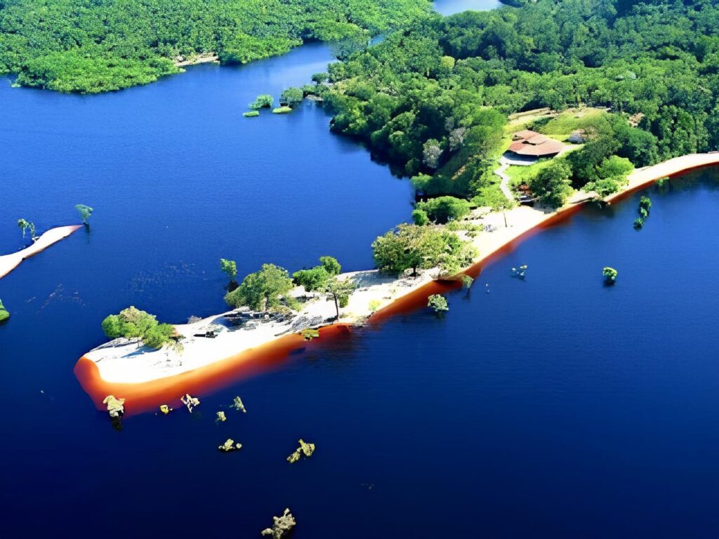 A peaceful view of Praia do Tupé, with its calm waters and lush greenery, located near Manaus in the Brazilian Amazon.