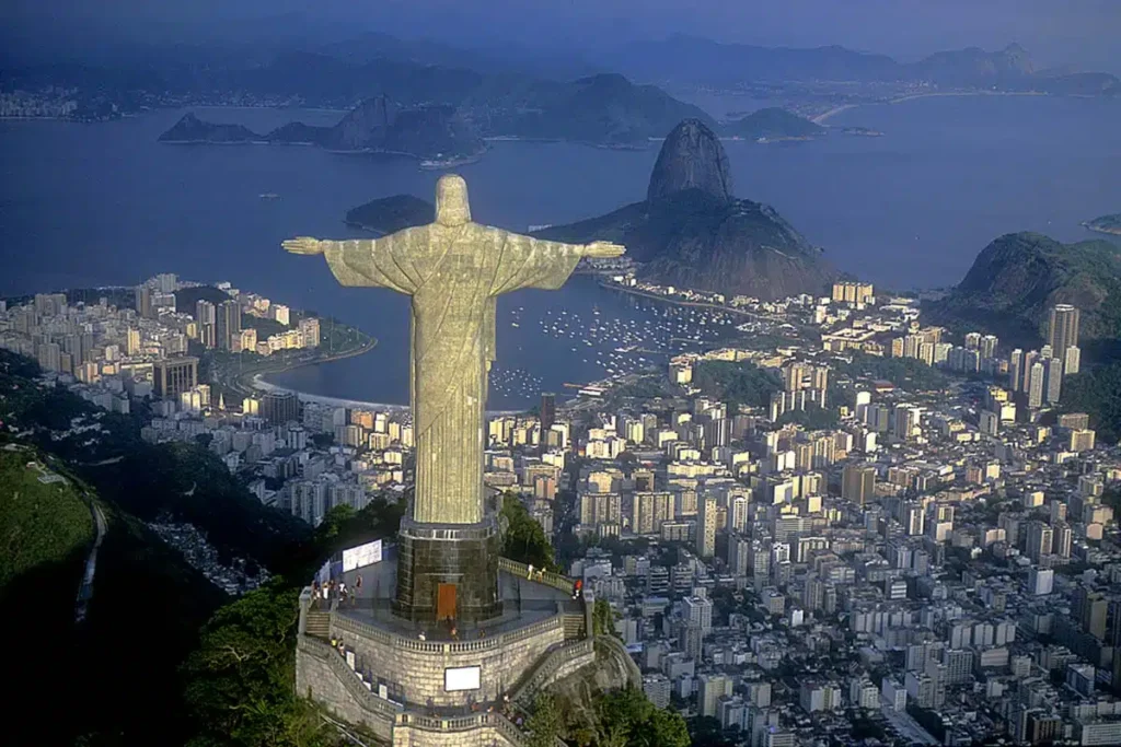 The Christ the Redeemer statue stands tall on Corcovado Mountain, with the stunning backdrop of Guanabara Bay, showcasing Rio de Janeiro's breathtaking skyline.