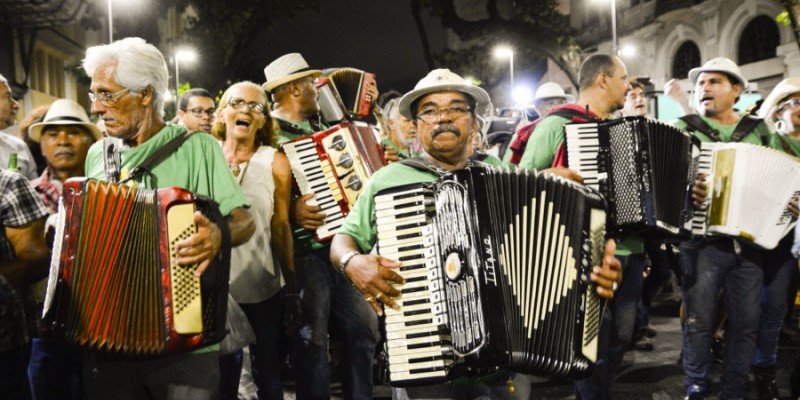 A couple dancing forró, with vibrant traditional clothing, capturing the joyful spirit and rhythm of Brazil's iconic northeastern dance.