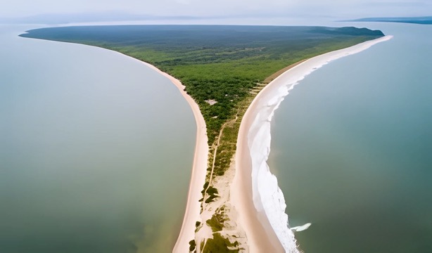 Aerial view of the stunning isthmus of Ilha do Mel, Brazil, where two sides of the island meet in a narrow strip of golden sand, surrounded by crystal-clear waters.