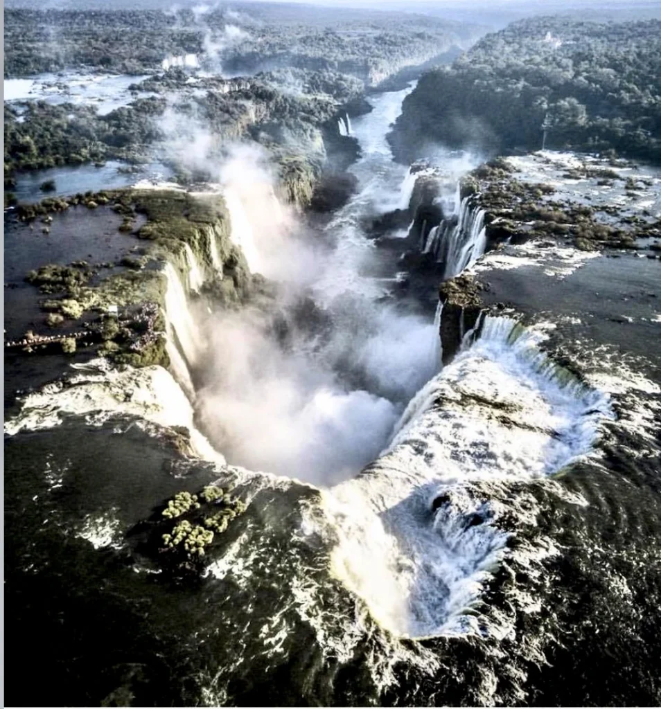 Stunning aerial shot of the Devil’s Throat (Garganta do Diabo), the most powerful section of Iguazu Falls, with mist rising from the plunging water