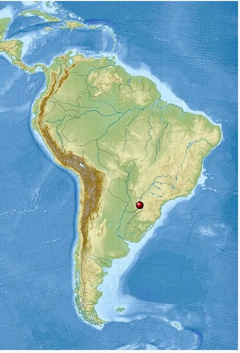 A map of South America with a red marker indicating the location of Iguazu Falls on the border between Brazil and Argentina.