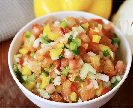 "Colorful Brazilian vinagrete made with chopped tomatoes, onions, and bell peppers, served as a zesty side dish for Feijoada."

